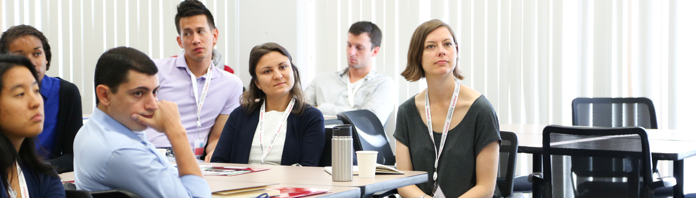 Photo of a group of students in a classroom paying attention..