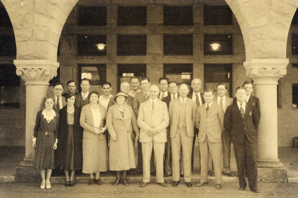 An old black and white photo of an earlier class of 20 students