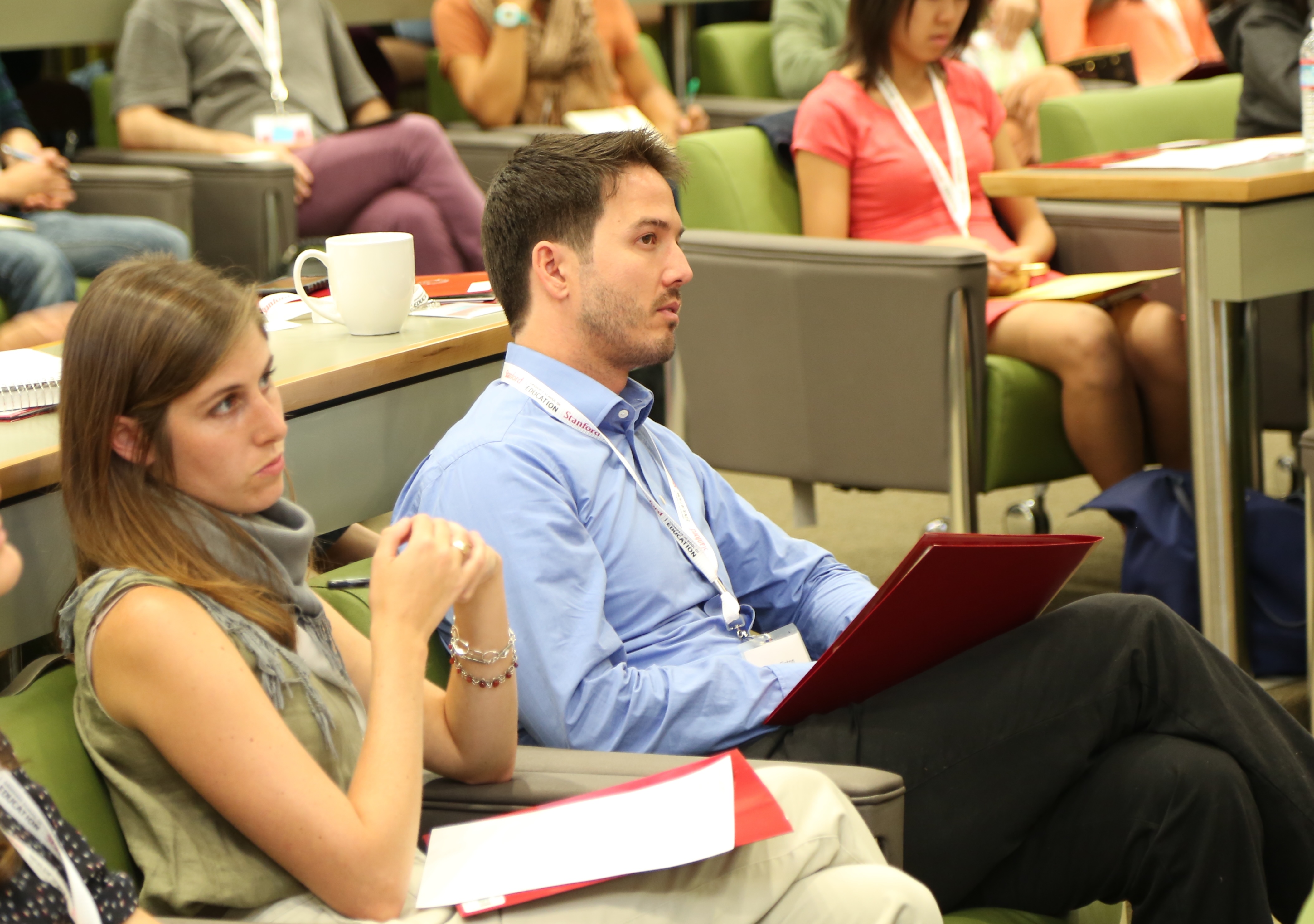 Attendees at an event listening to a presenter 