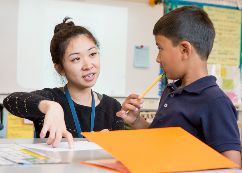 STEP student working with a child on an assignment