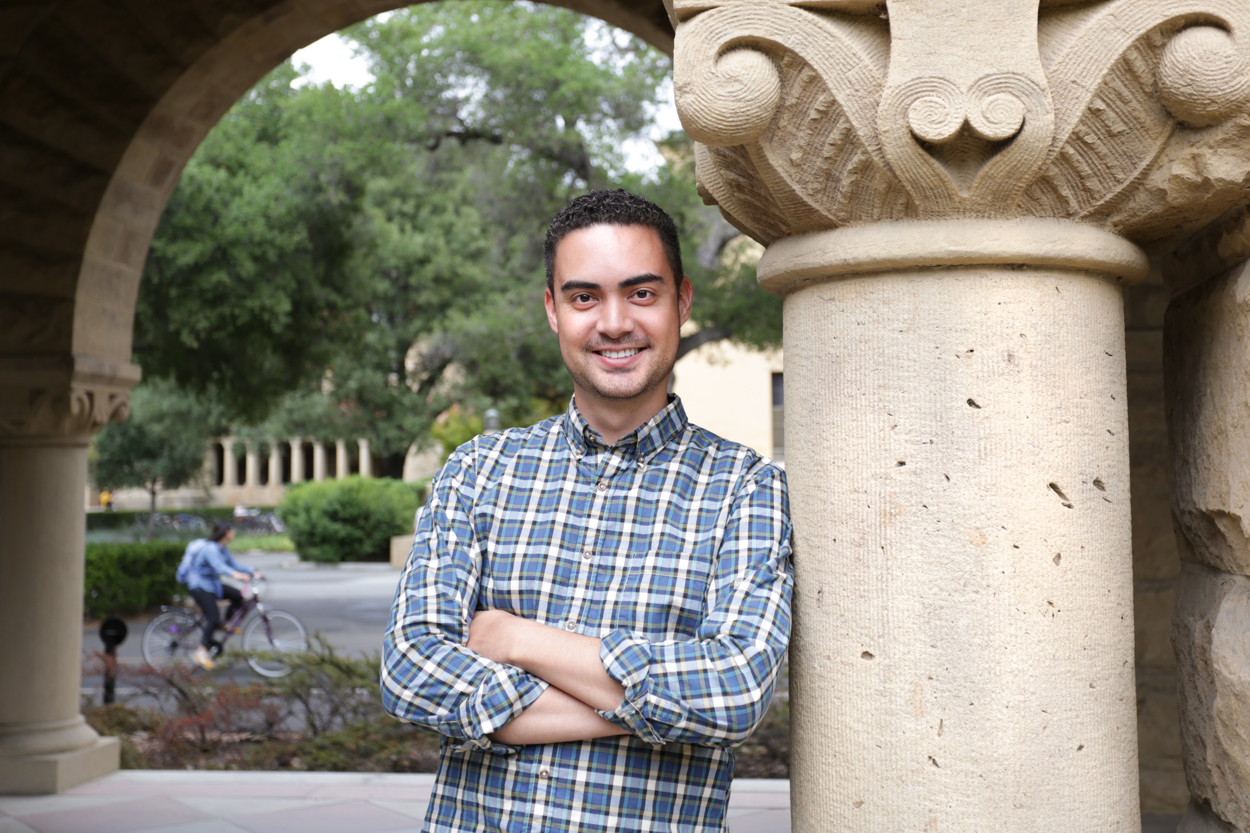 Photo of Tanner Vea leaning on a column