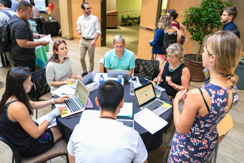 Photo of a group of alumni around a table.