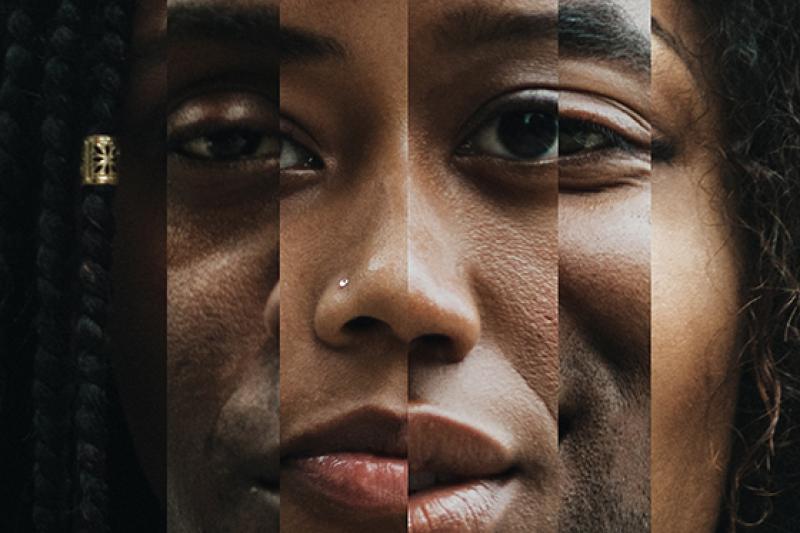 Photo of a Black woman's face in a prism-like mirror