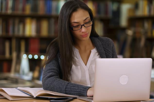 Photo of woman scholar working on her computer