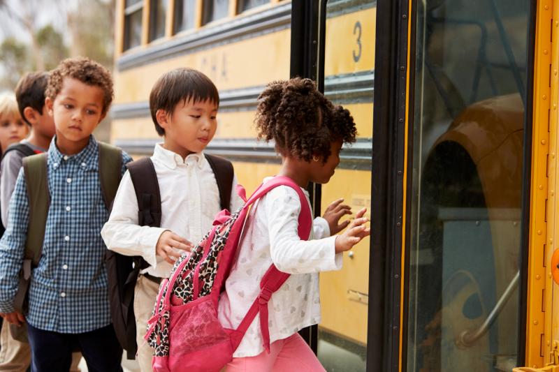 Kids getting onto a school bus