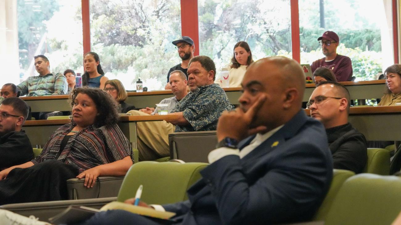 Participants (including Professor Bryan A. Brown, in foreground, and Professor Emeritus John Baugh, center background) look on and listen during the third annual Ball Lecture