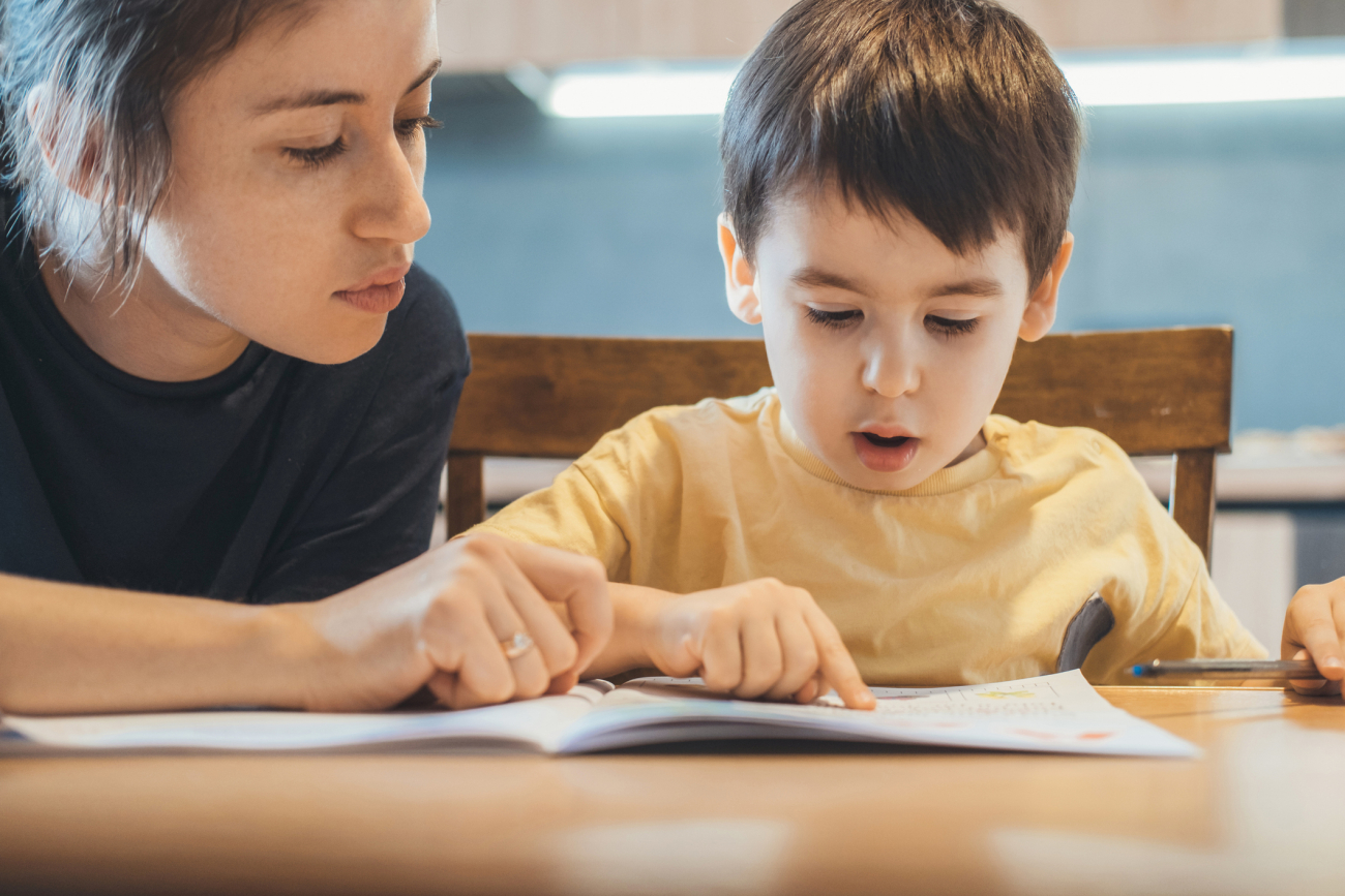 Teacher with student learning to read