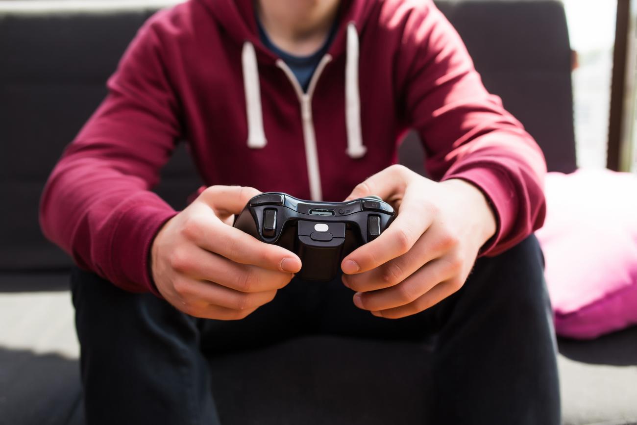 Parents and teachers can navigate the Fortnite craze by setting limits but also being involved, Stanford experts say. (Photo: F8studio/Adobe Stock) Man playing video games. Photo by Adobe Stock