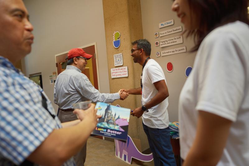 Deepak Varuvel Dennison (back right) introduced O Dinos, an interactive storybook series he developed with Janet Liu. (Photo: Ryan Zhang)