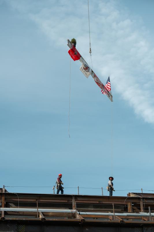 The beam is lowered so construction workers can attach it to the building. (Photo: Ryan Zhang)