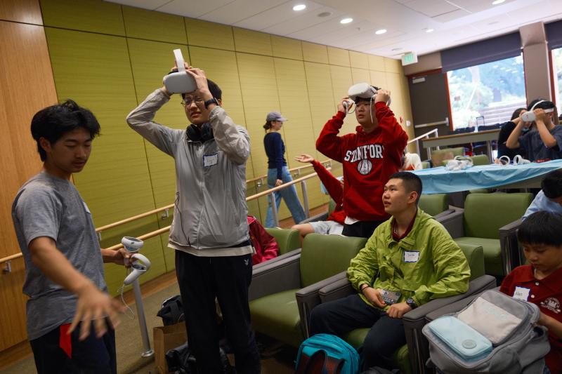 Attendees try out Univirtual Academy, a virtual reality tool created by Alex Stolyarik and Masaki Nakamura to build collaboration skills. (Photo: Ryan Zhang)