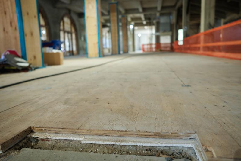 Workers cover the floors and columns in the the north building's historic lobby  for preservation. (Photo: Ryan Zhang)