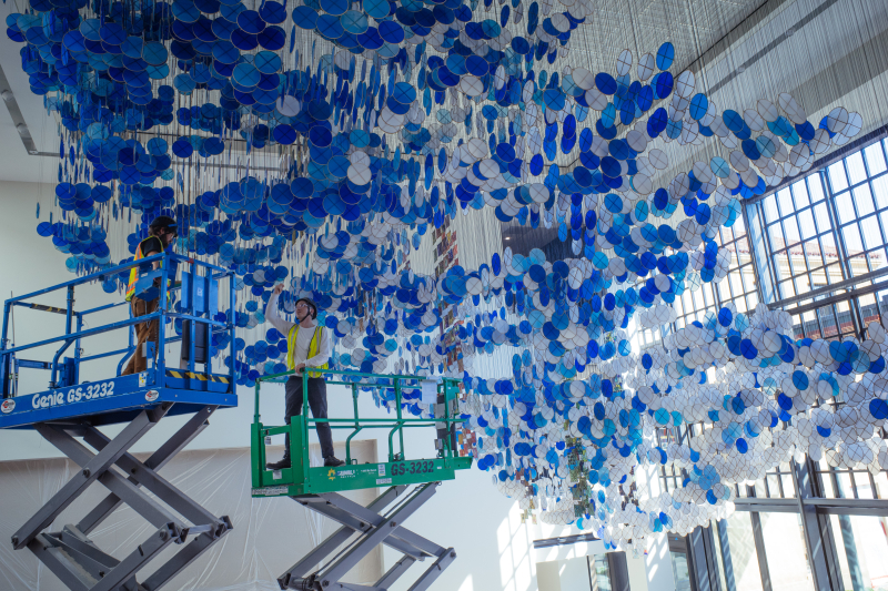 Wade Cotton (center) works on installing the piece in the days before the GSE's new campus opening. (Photo: Taylor Jones)
