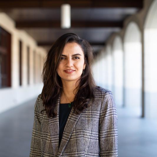 Faculty member Shima Salehi, photographed standing in a Stanford arcade