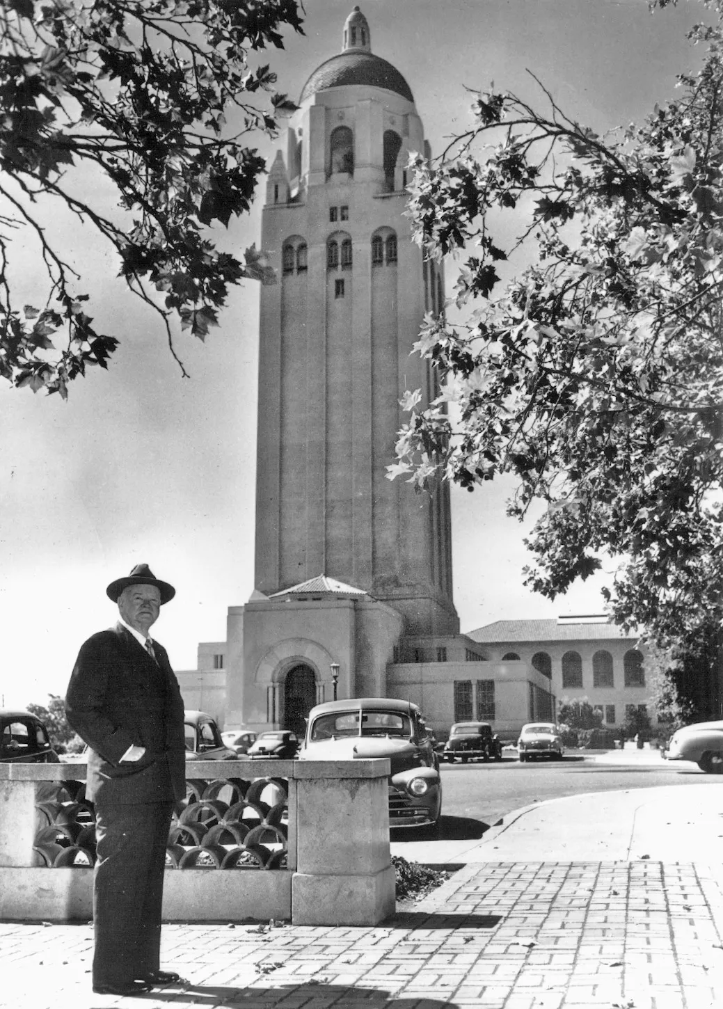 Historic photo of Herbert Hoover standing in front of Hoover Tower