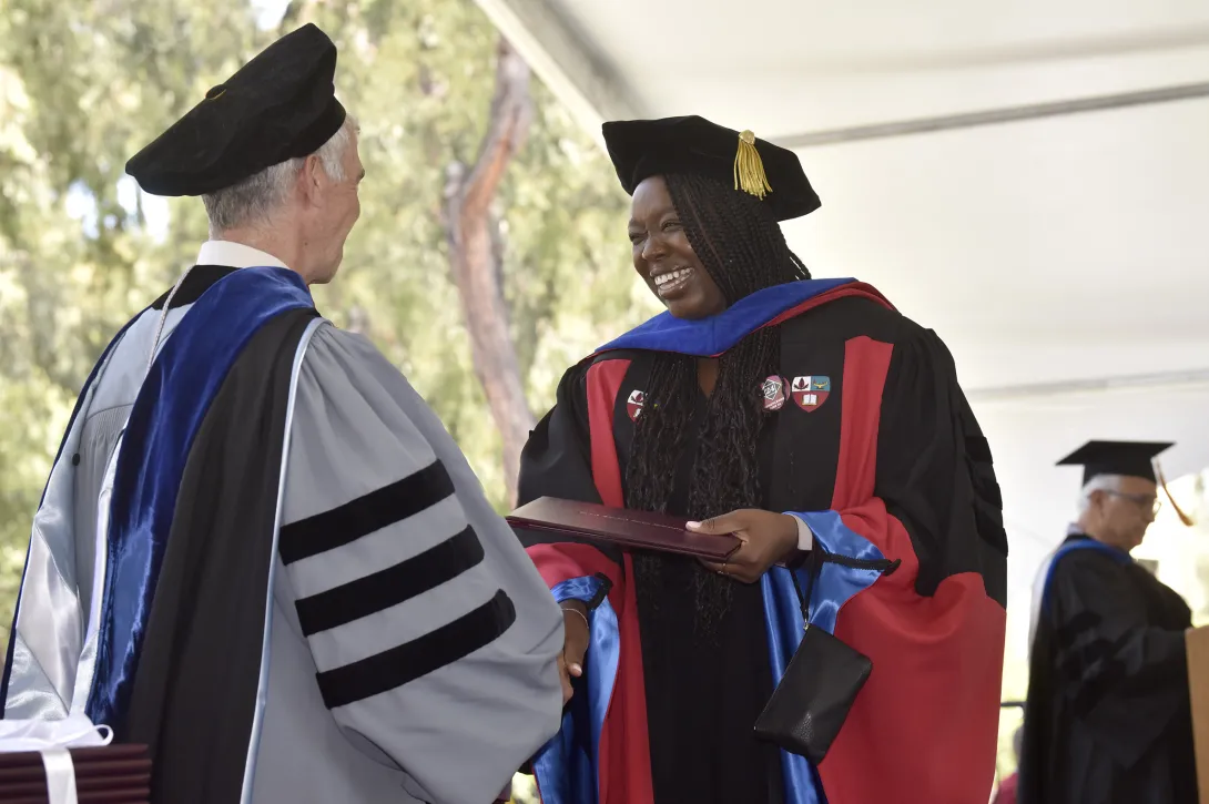 Kemi Oyewole, PhD ’24, accepts her diploma from Dean Dan Schwartz.