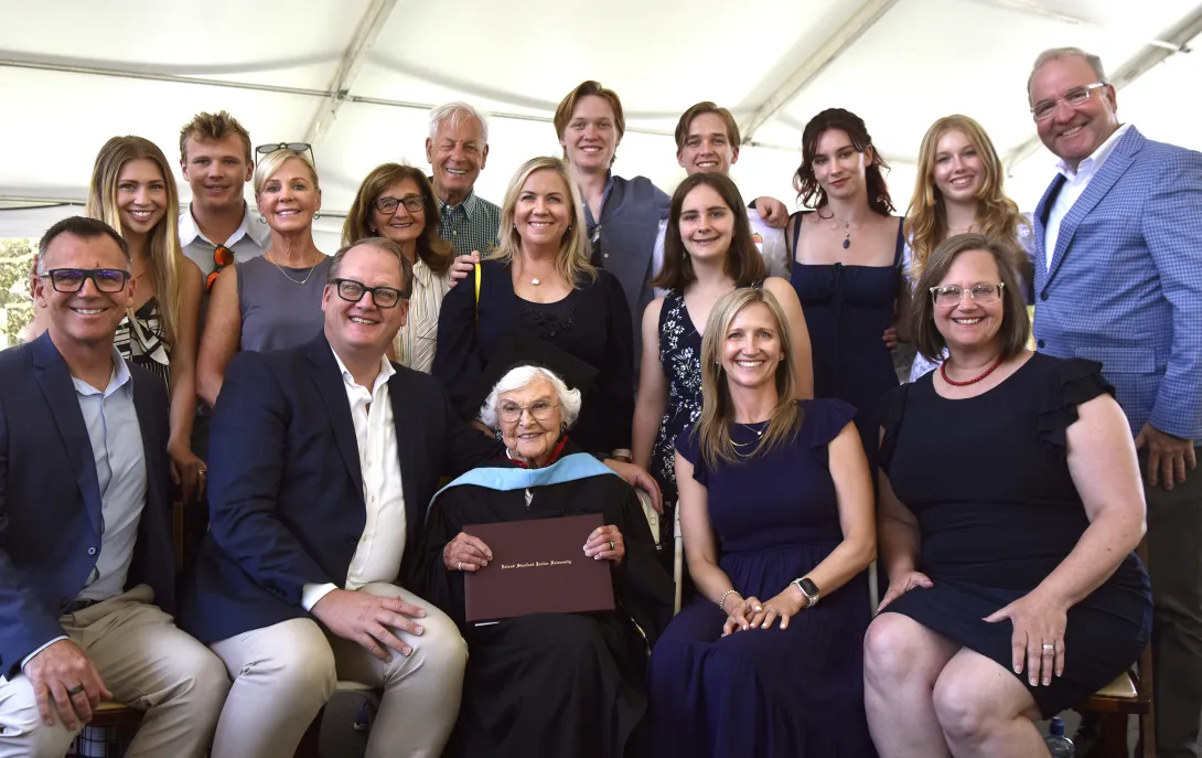 Virginia "Ginger" Hislop (center) holds her long-awaited master's of education diploma surrounded by 16 family members.