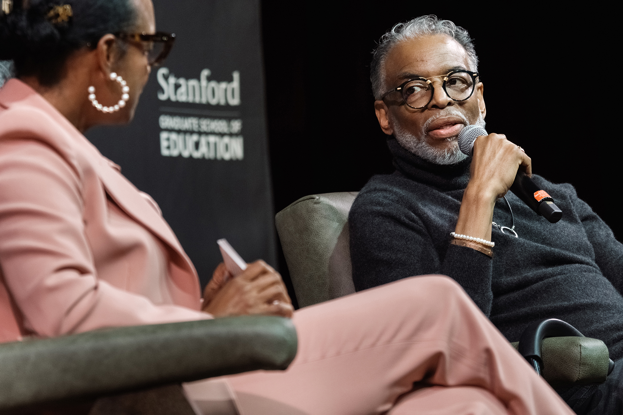 LeVar Burton, with a mic, in coversation with Professor Maisha Winn on stage at the Graduate School of Education's Cubberley Lecture 2026