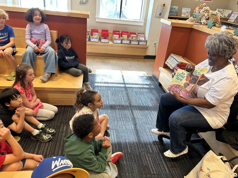 Biddle reading story to a group of young children