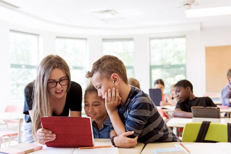 Students in a classroom using a digital tablet