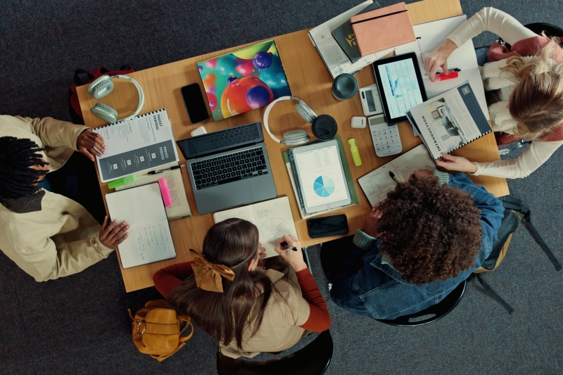 bove, study group and college with friends in library for research project, team or education.