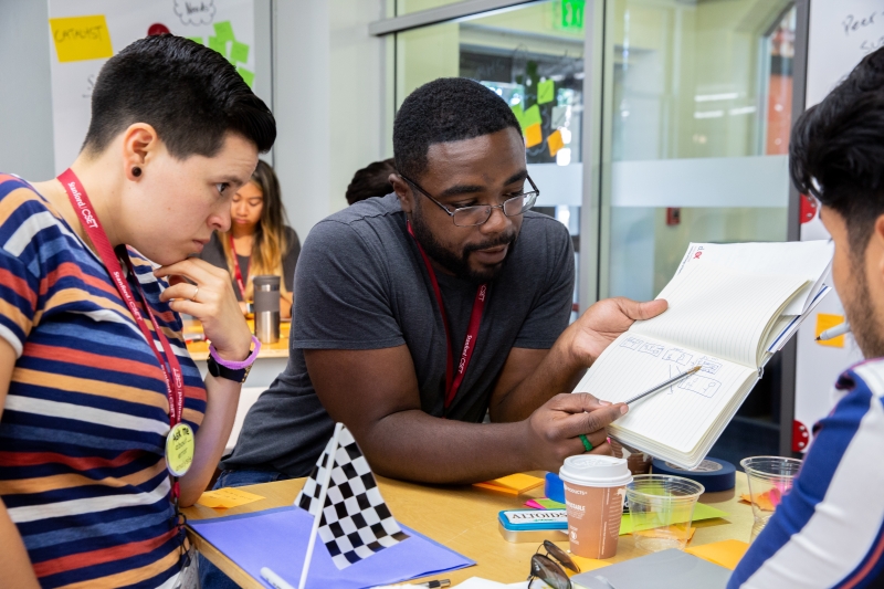 A teacher works with his student in a classroom.