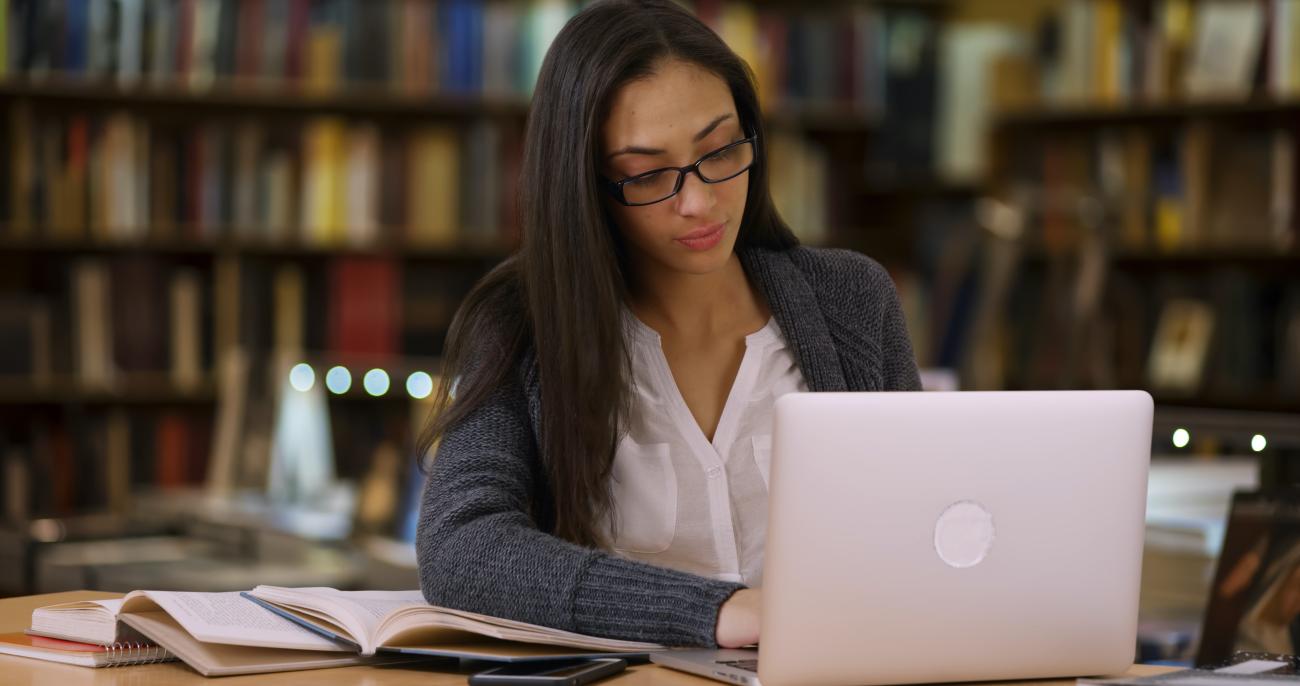 Photo of woman scholar working on her computer